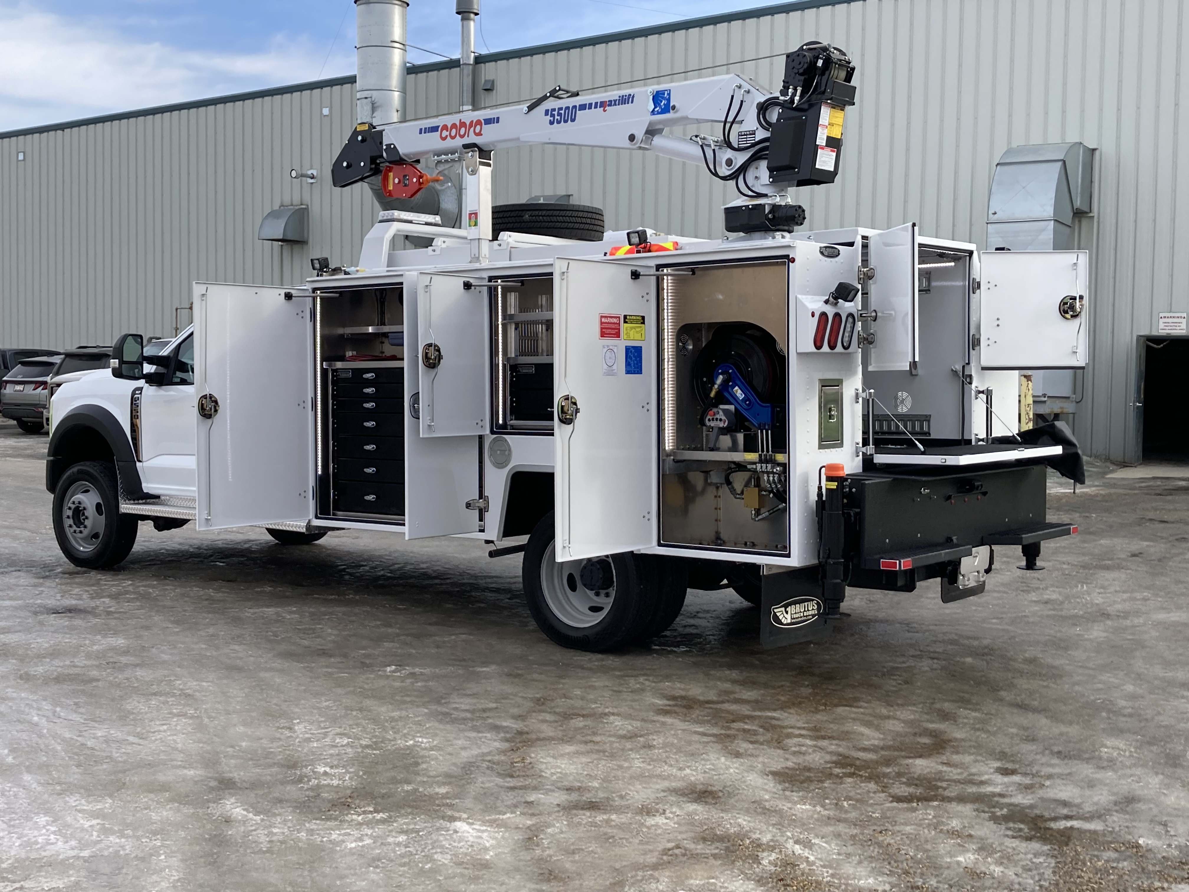 Service truck body with crane and organized compartment storage
