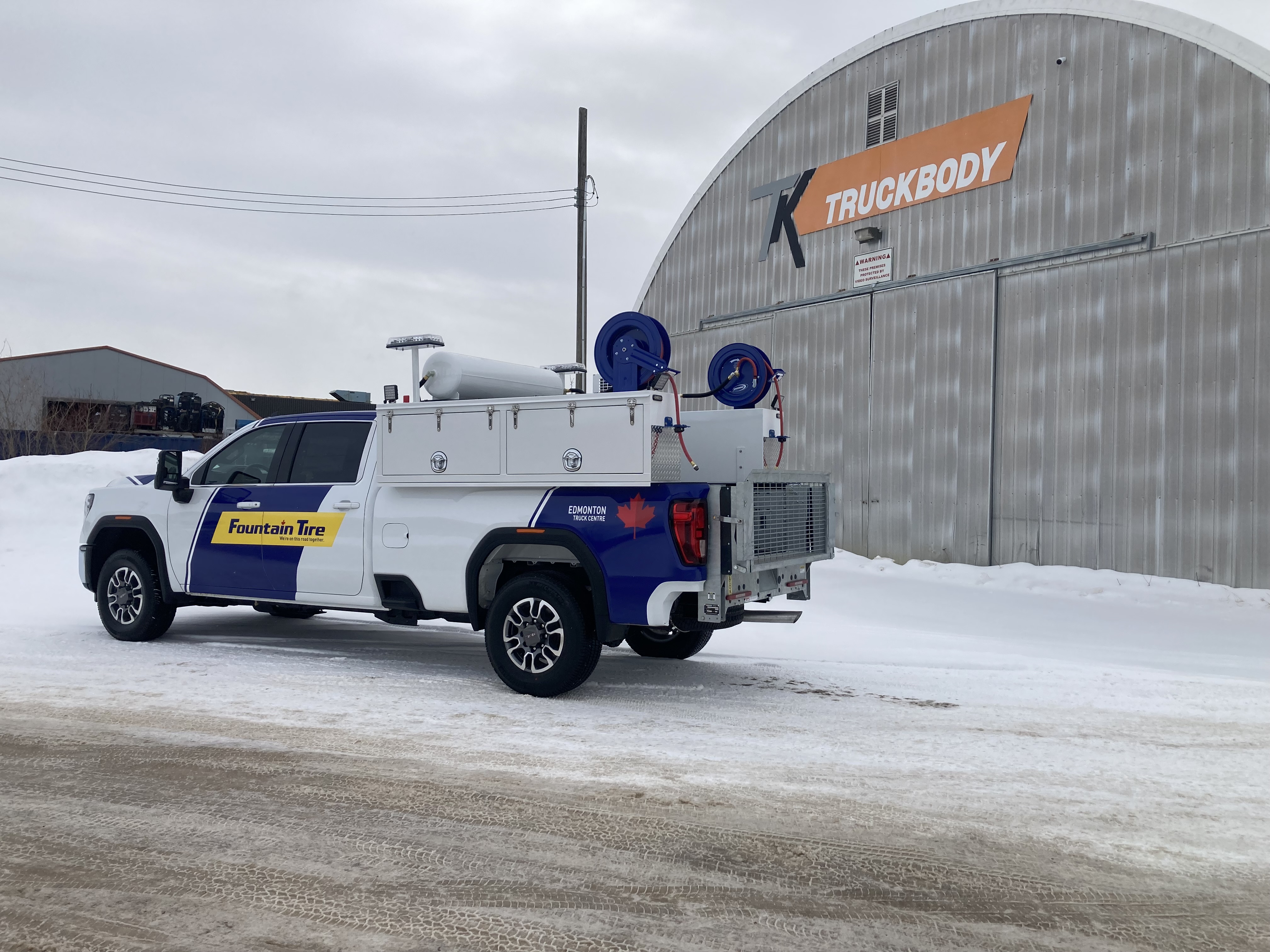 Tire service truck body with equipment and field-service storage