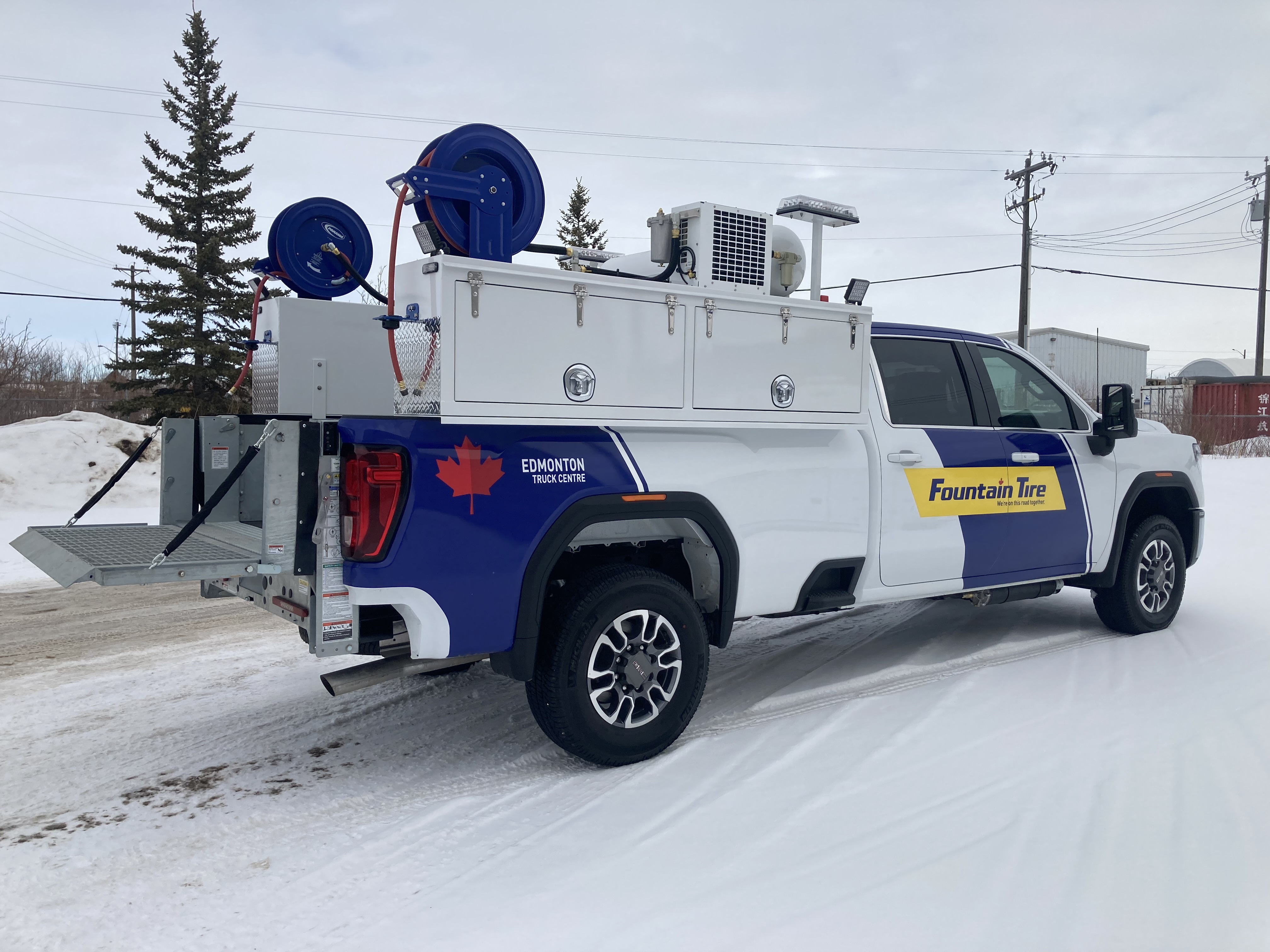 Side view of TK tire service truck body with rear platform and hose reels